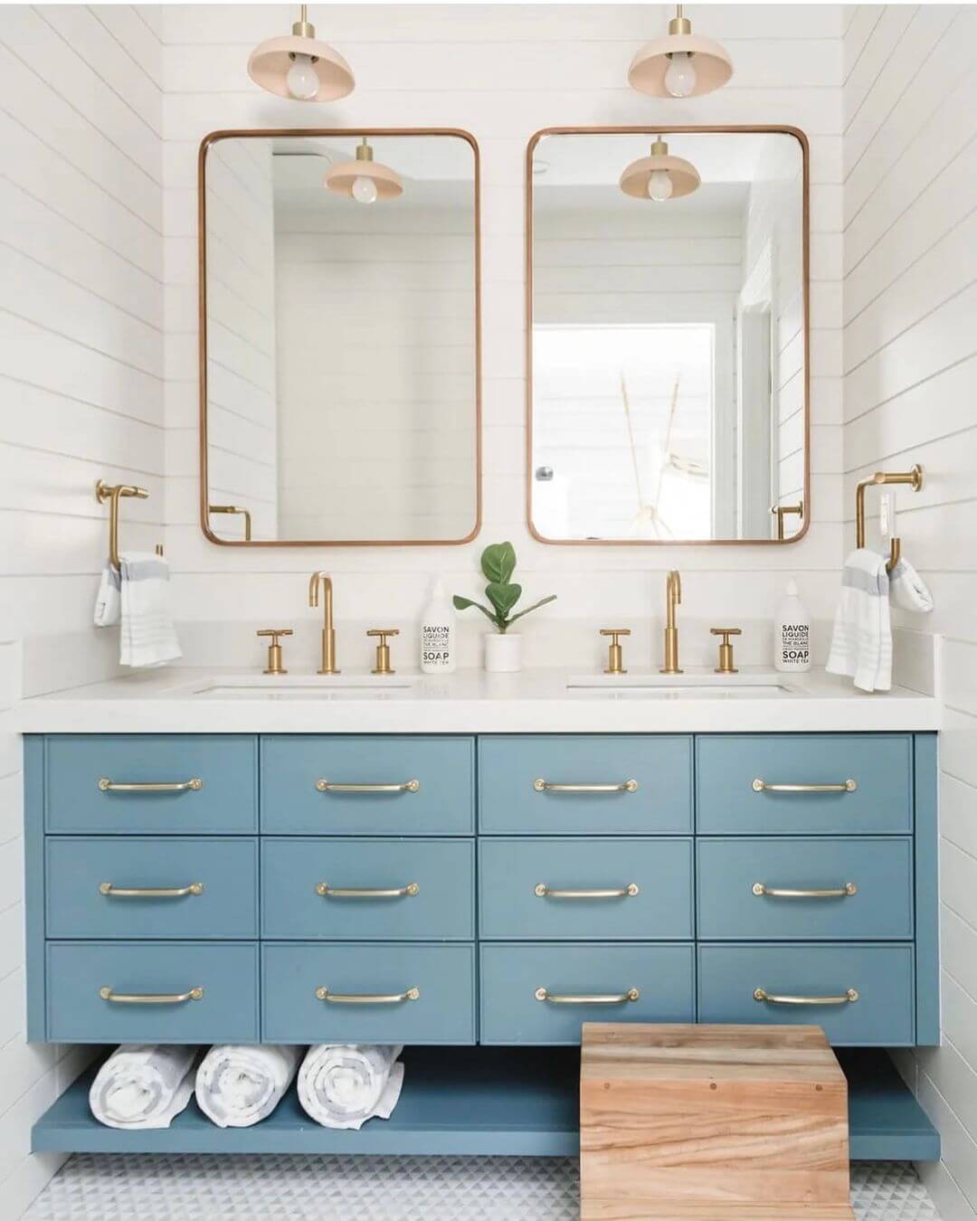 Blue Shiplap Walls Frame Double Vanity With Copper-Rimmed Mirrors
