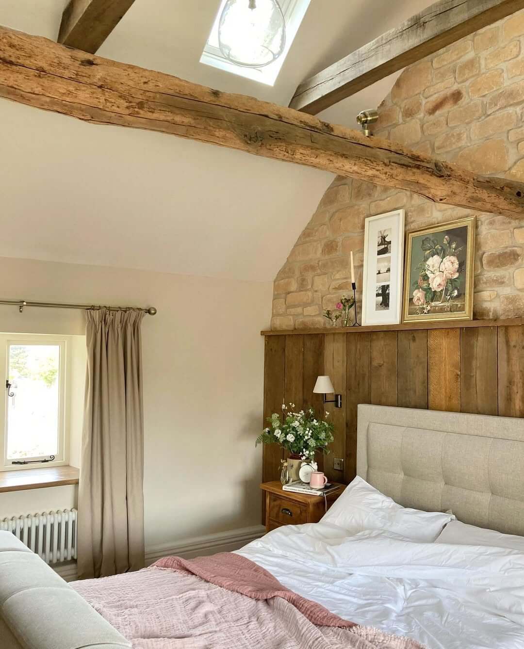 Wood paneled headboard wall creates a rustic backdrop