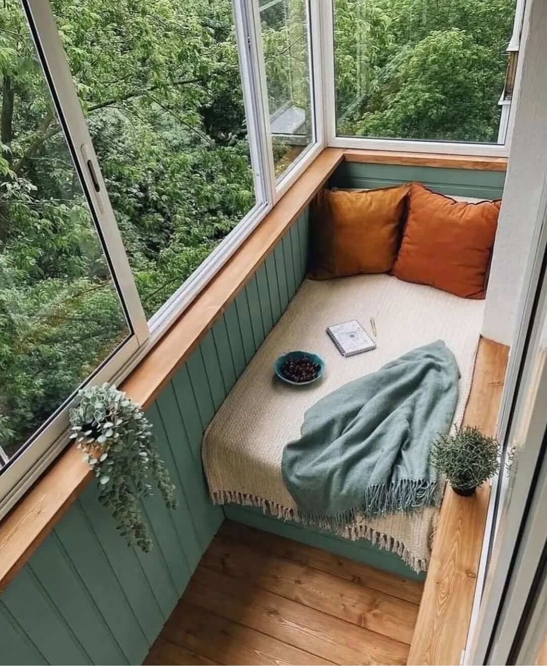 Design a window nook with plush cushions for quiet relaxation