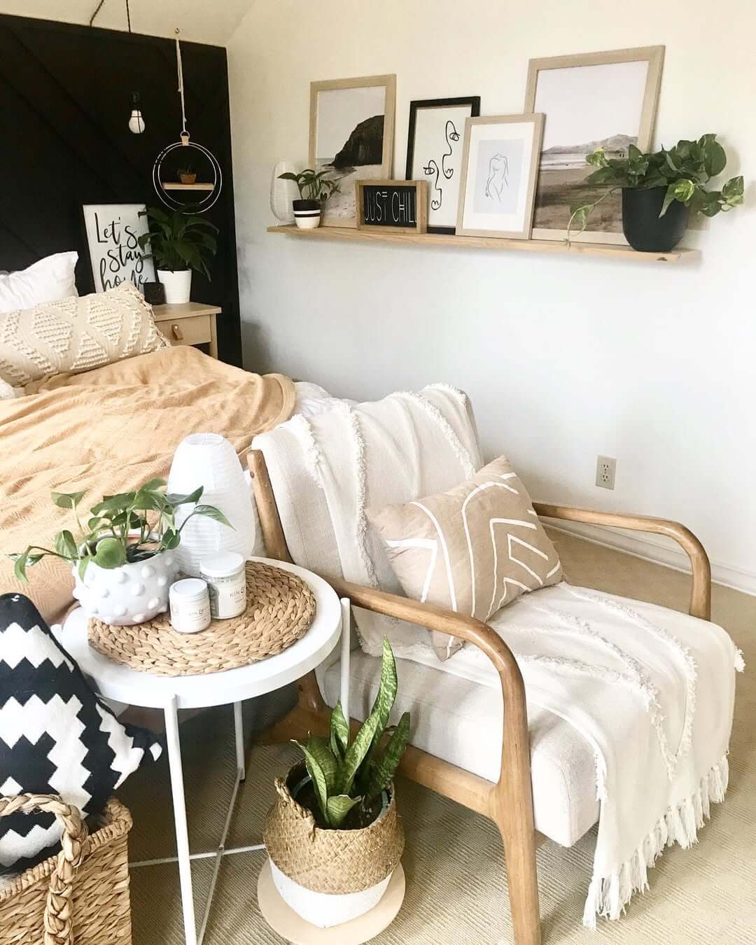 Layer art and plants on a floating wood shelf above the bed