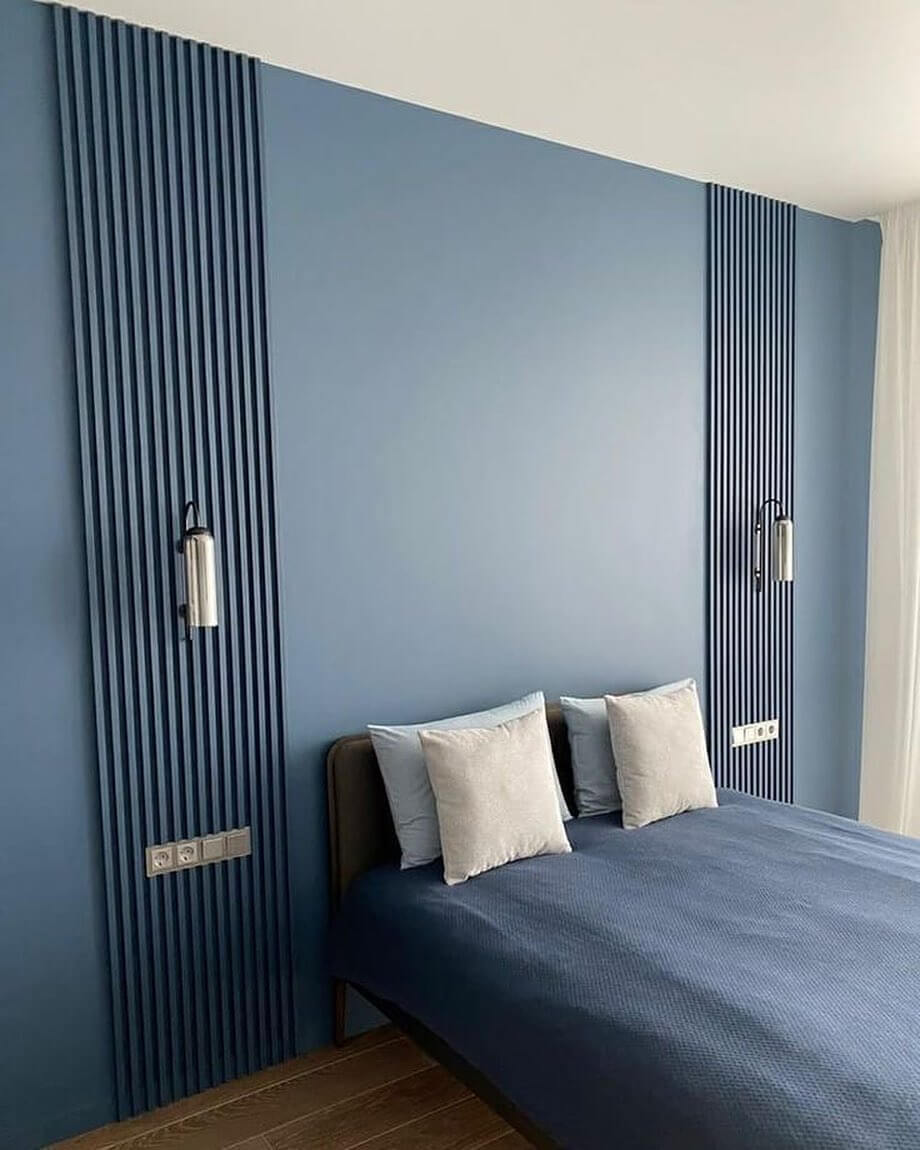 Vertical Wood Slats Add Architectural Interest Above the Bed