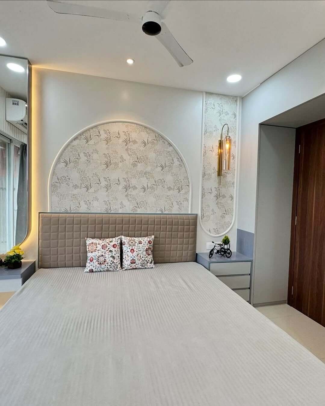 Arched Wallpaper Accent Wall Frames the Bed