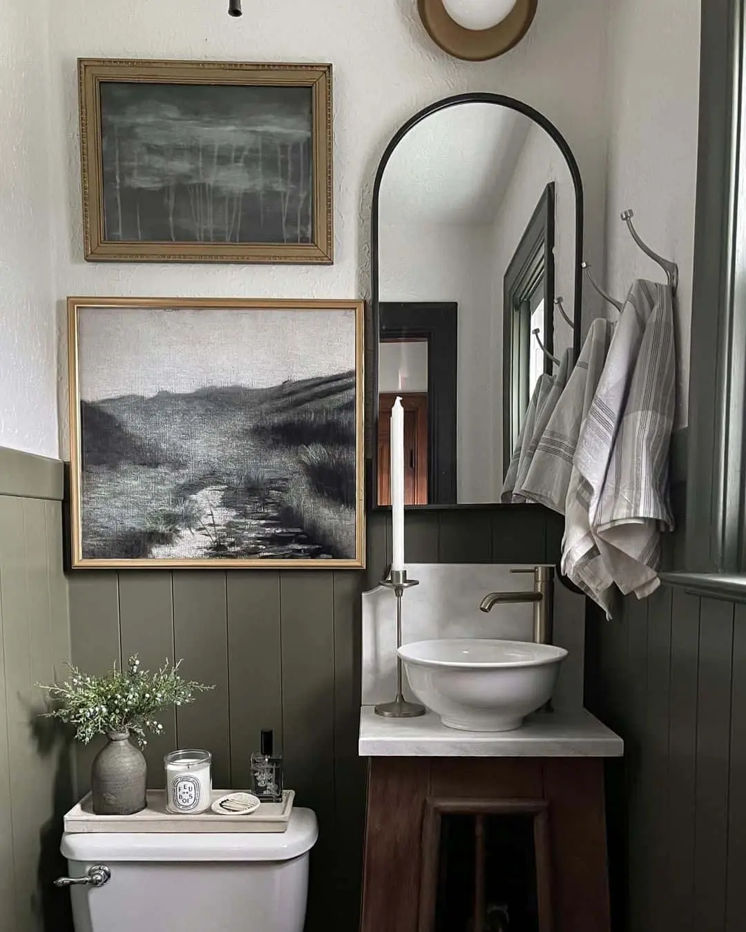 Monochromatic Landscape Art Adds Moody Depth Above the Toilet