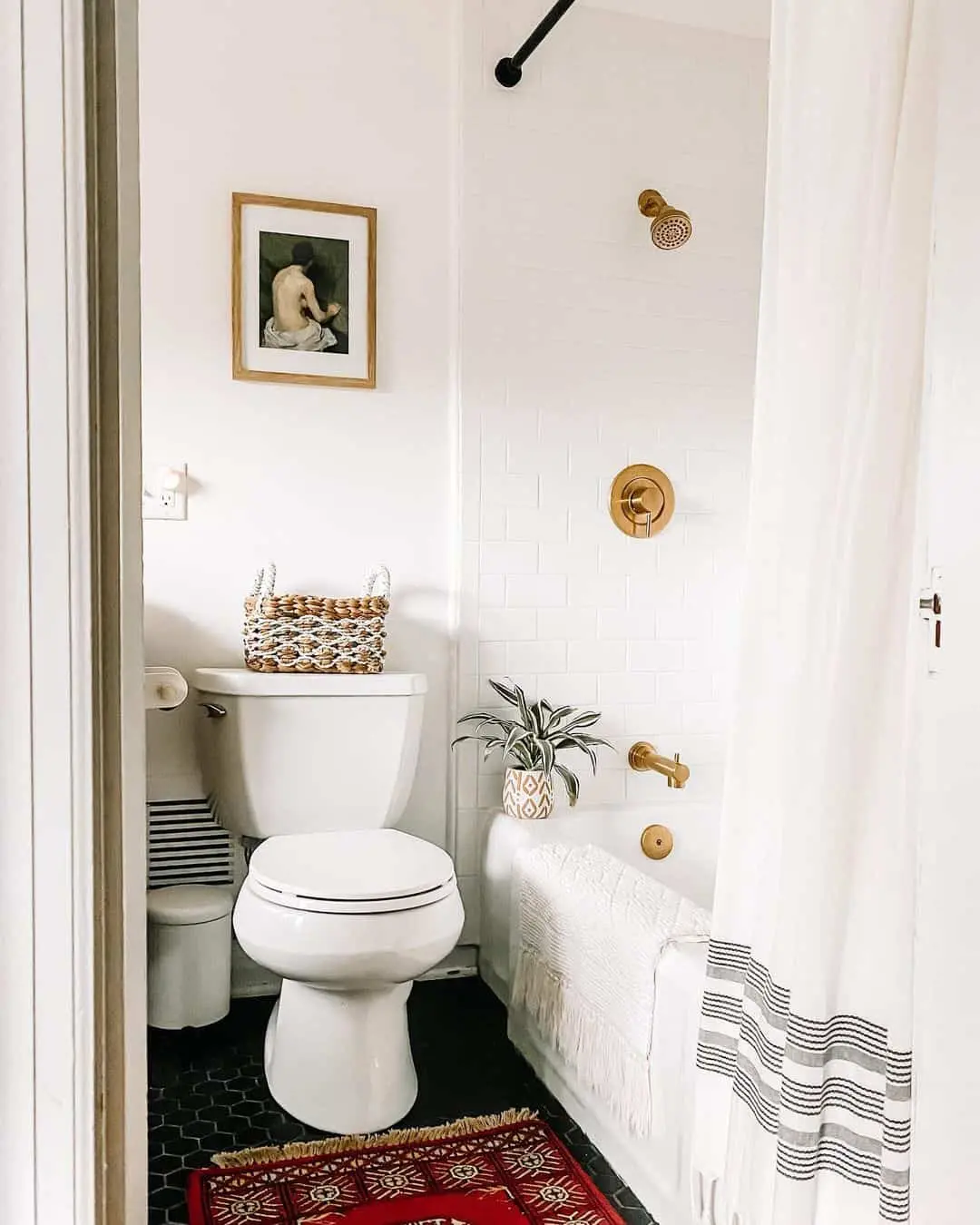 Framed Vintage Art Adds a Classic Touch Above the Toilet
