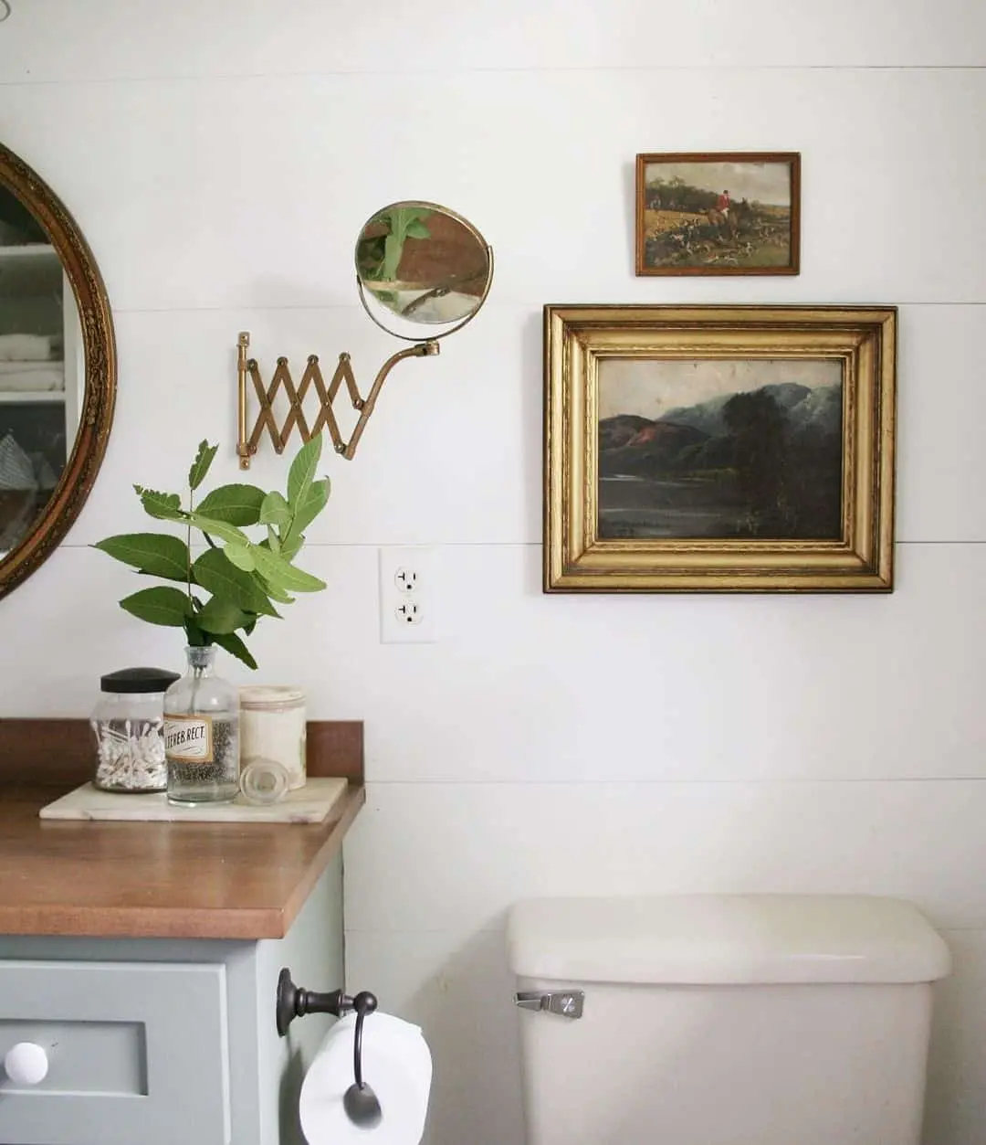 Gold Framed Landscape Painting Adds Moody Depth Above Toilet