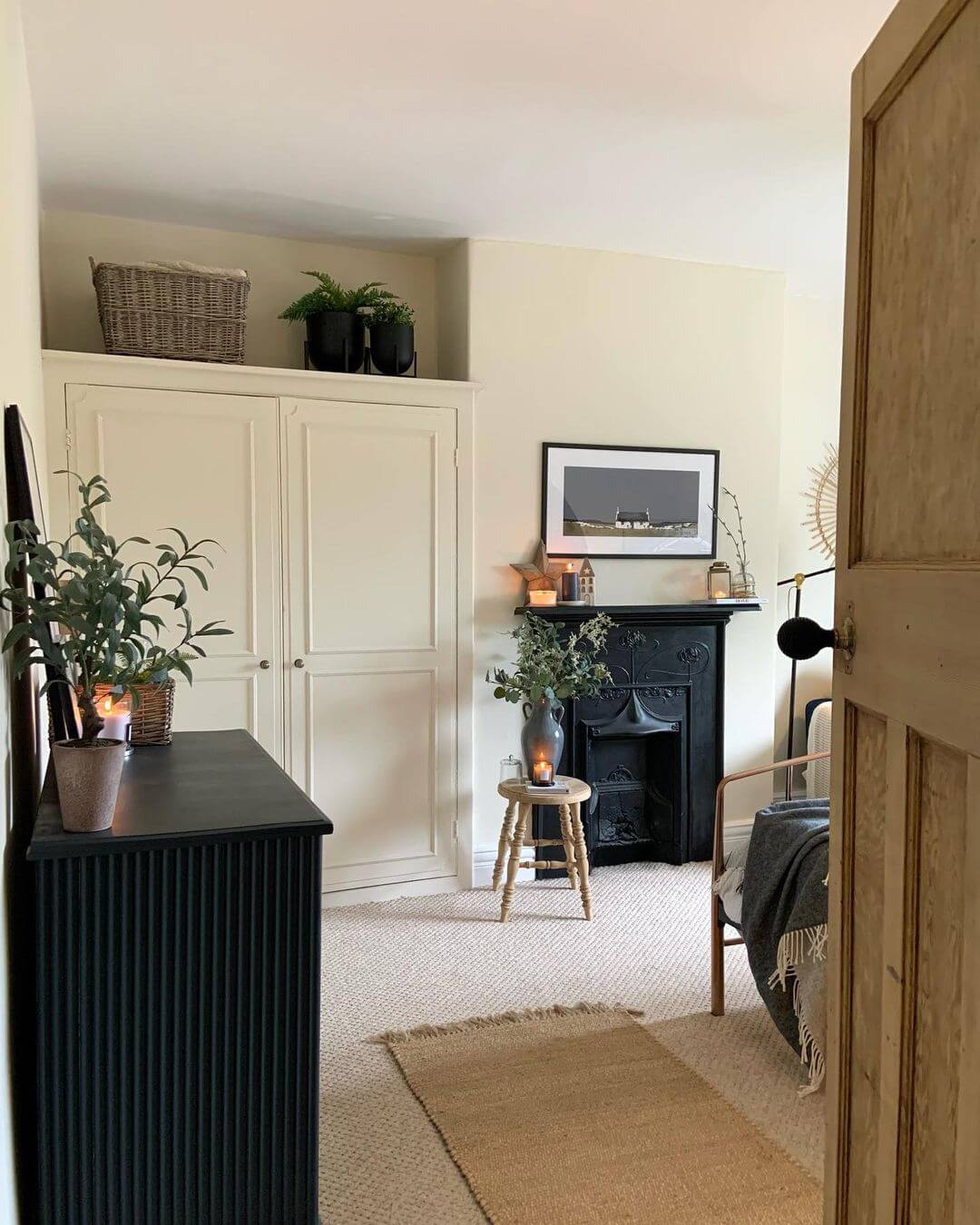 Black Cast Iron Fireplace with Minimalist Landscape Art