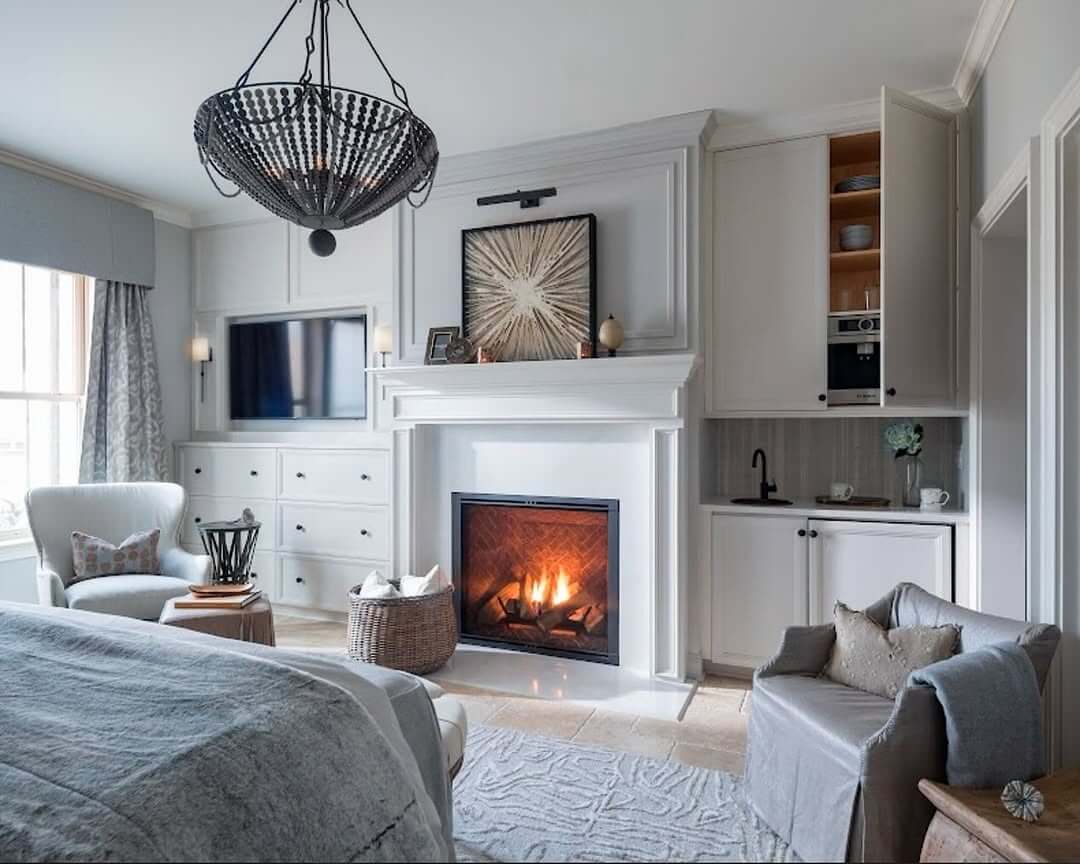 White Fireplace with Built-in Cabinetry and Coffee Station