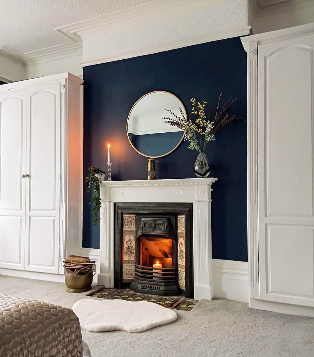 Ornate Fireplace with Detailed Tile Inlay and Mirror