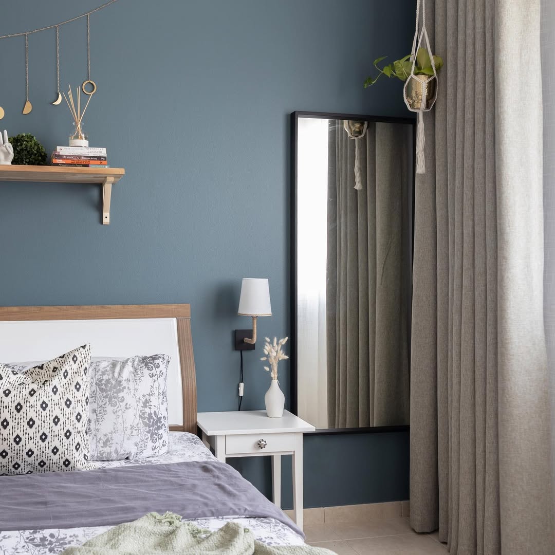 Expand Space Beside Curtains with a Tall Black Framed Mirror