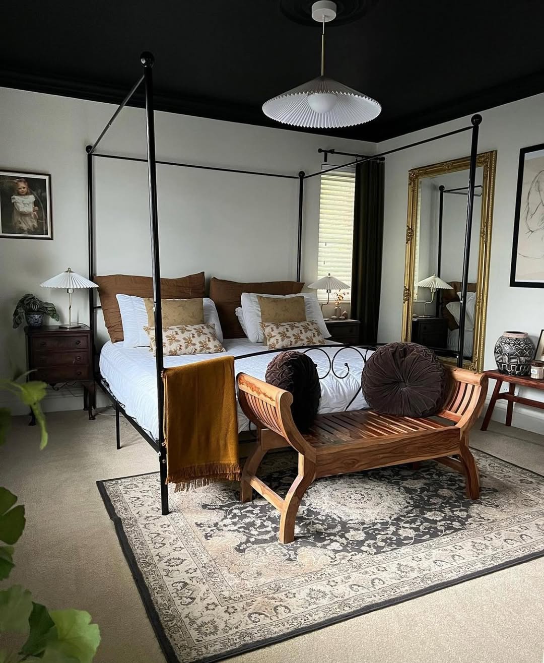 Ornate Gold Mirror Adds Glamour Beside Four-Poster Bed