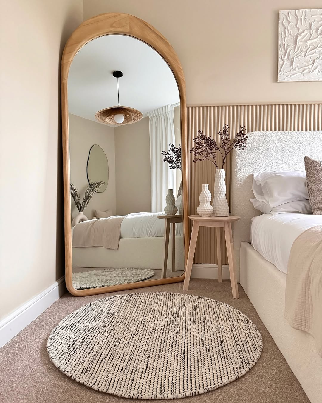 Natural Wood Arched Mirror Frames a Serene Bedroom Scene