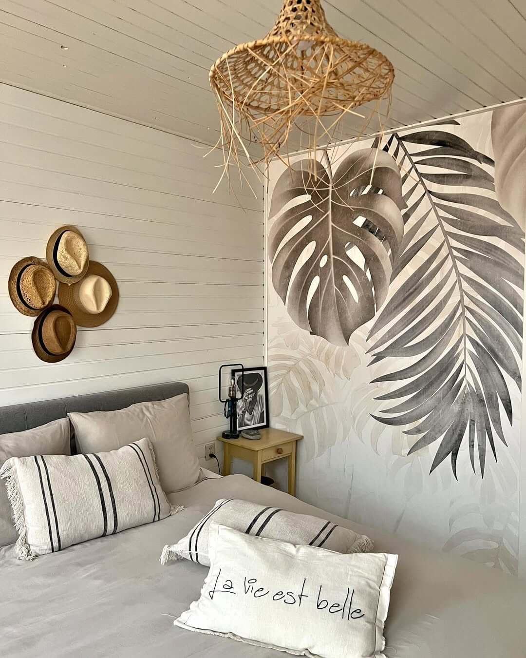 Monstera Leaf Wallpaper Creates a Tropical Bedroom Accent Wall