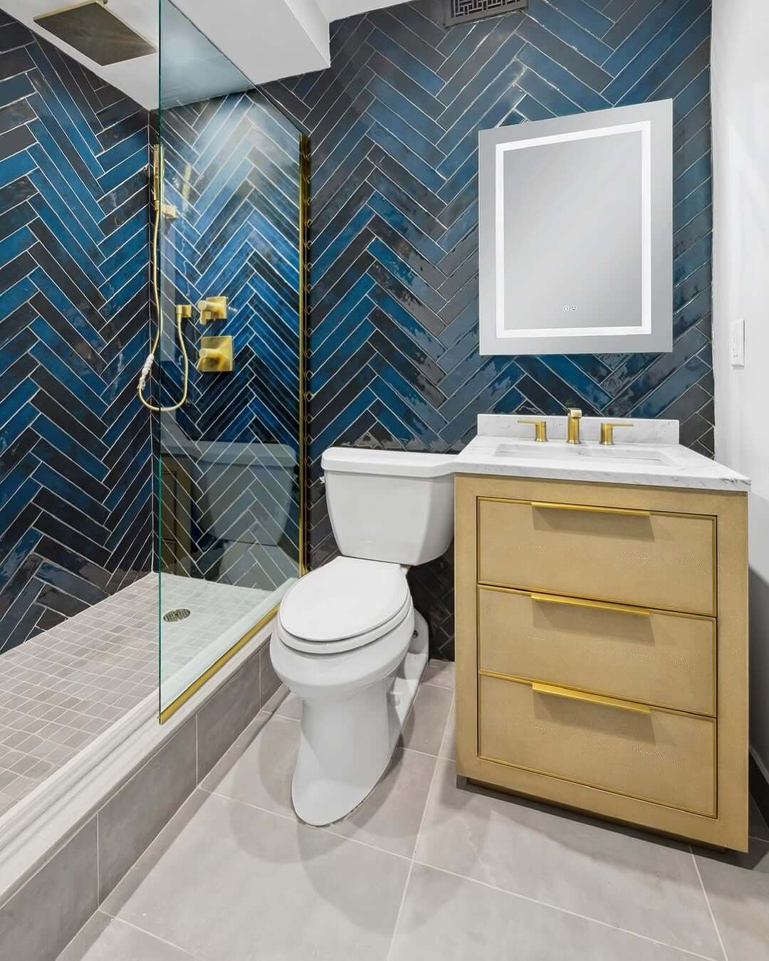 Herringbone Blue Tiles Create a Dramatic Shower Backdrop