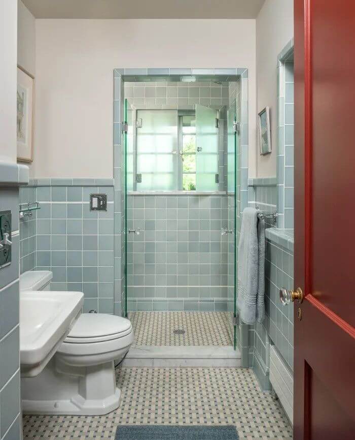 Subway Tile Walls and Floor Create a Cohesive Blue Bathroom