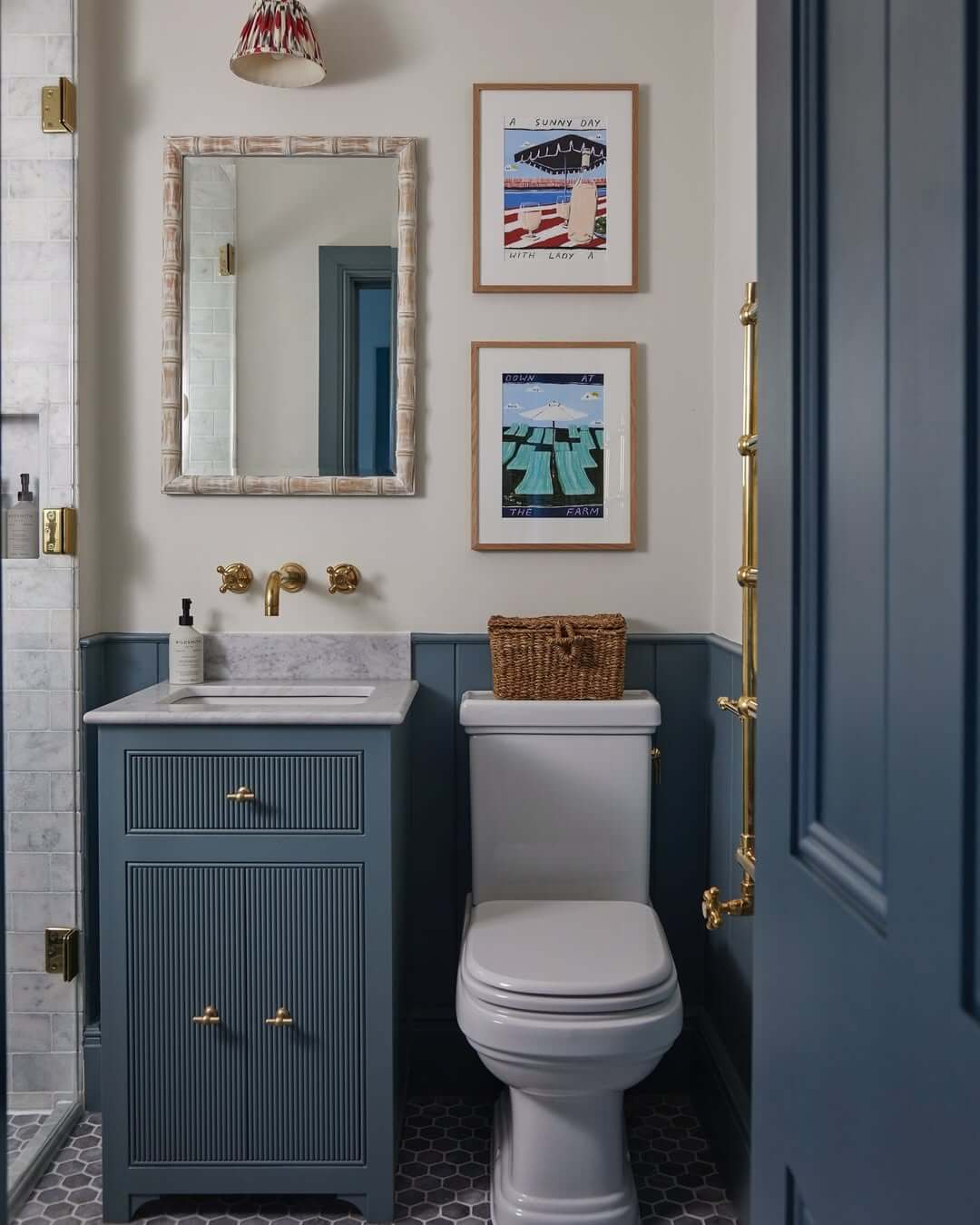 Framed Art Adds a Playful Beach Vibe Above Blue Wainscoting