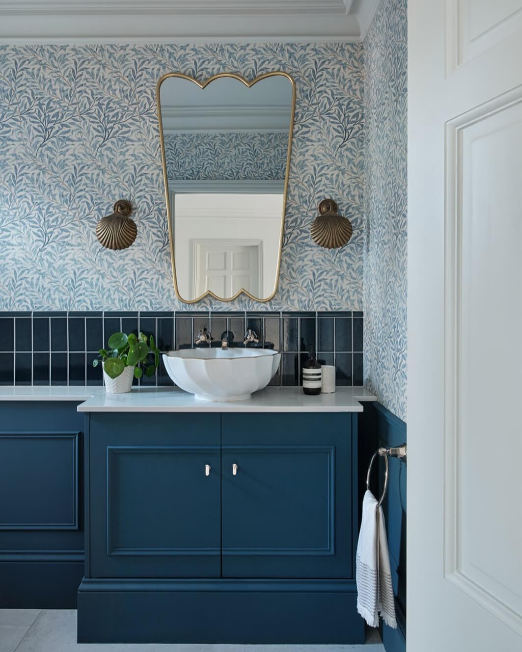 Deep Blue Vanity Pairs with a Scalloped Mirror and Shell Sconces
