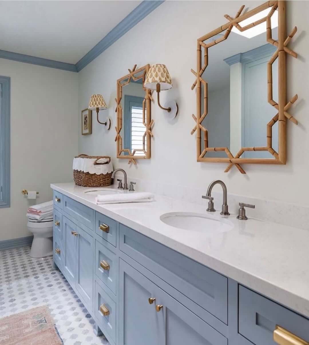 Bamboo-Framed Mirrors Add Natural Texture Above Blue Vanity