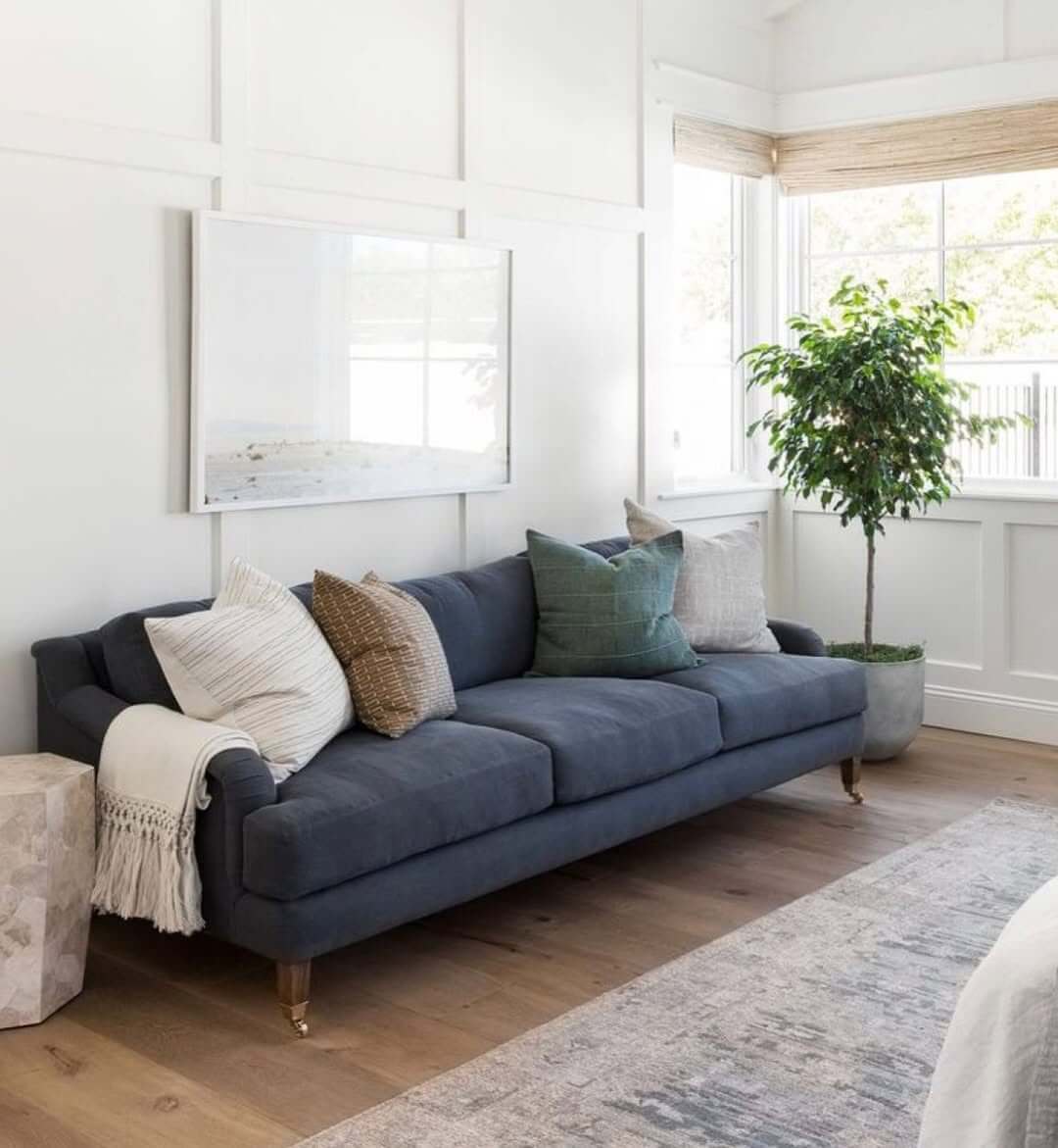 Large Horizontal Landscape Art Above Blue Sofa