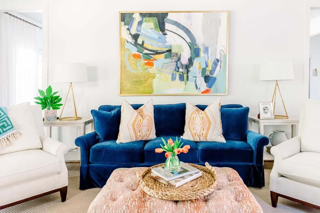 Introduce Color with Abstract Artwork Above a Deep Blue Sofa