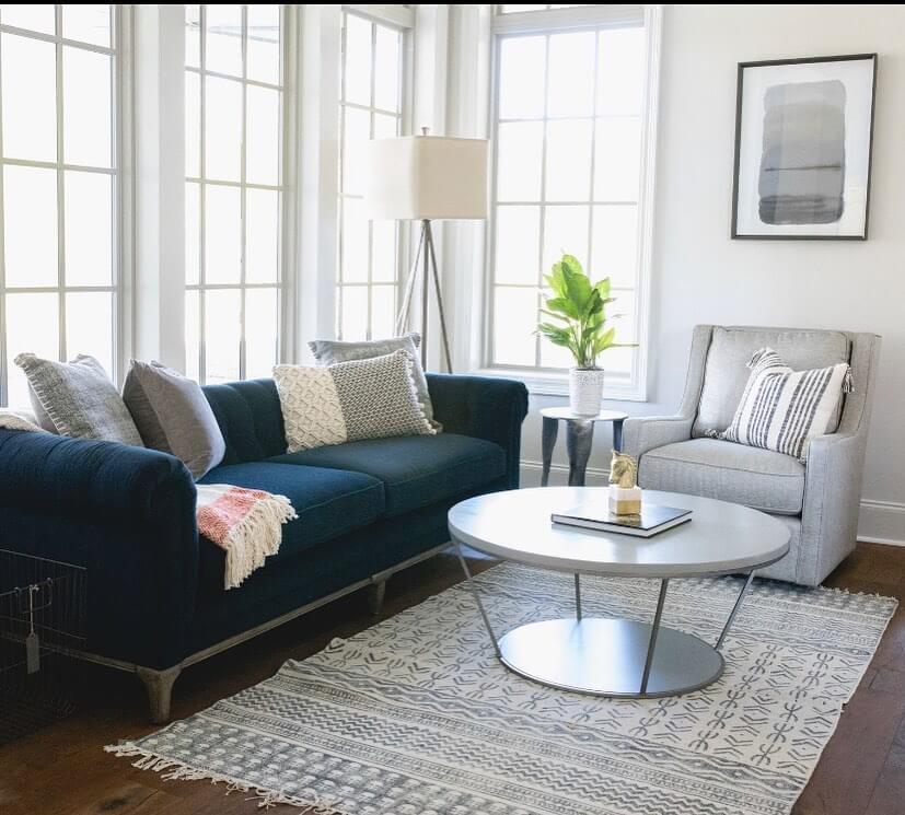 Incorporate a Round Coffee Table with a Mirrored Shelf