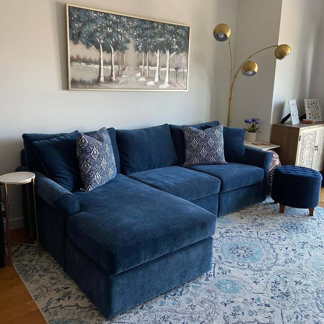 Ground Your Space with a Deep Blue Sectional and Patterned Rug