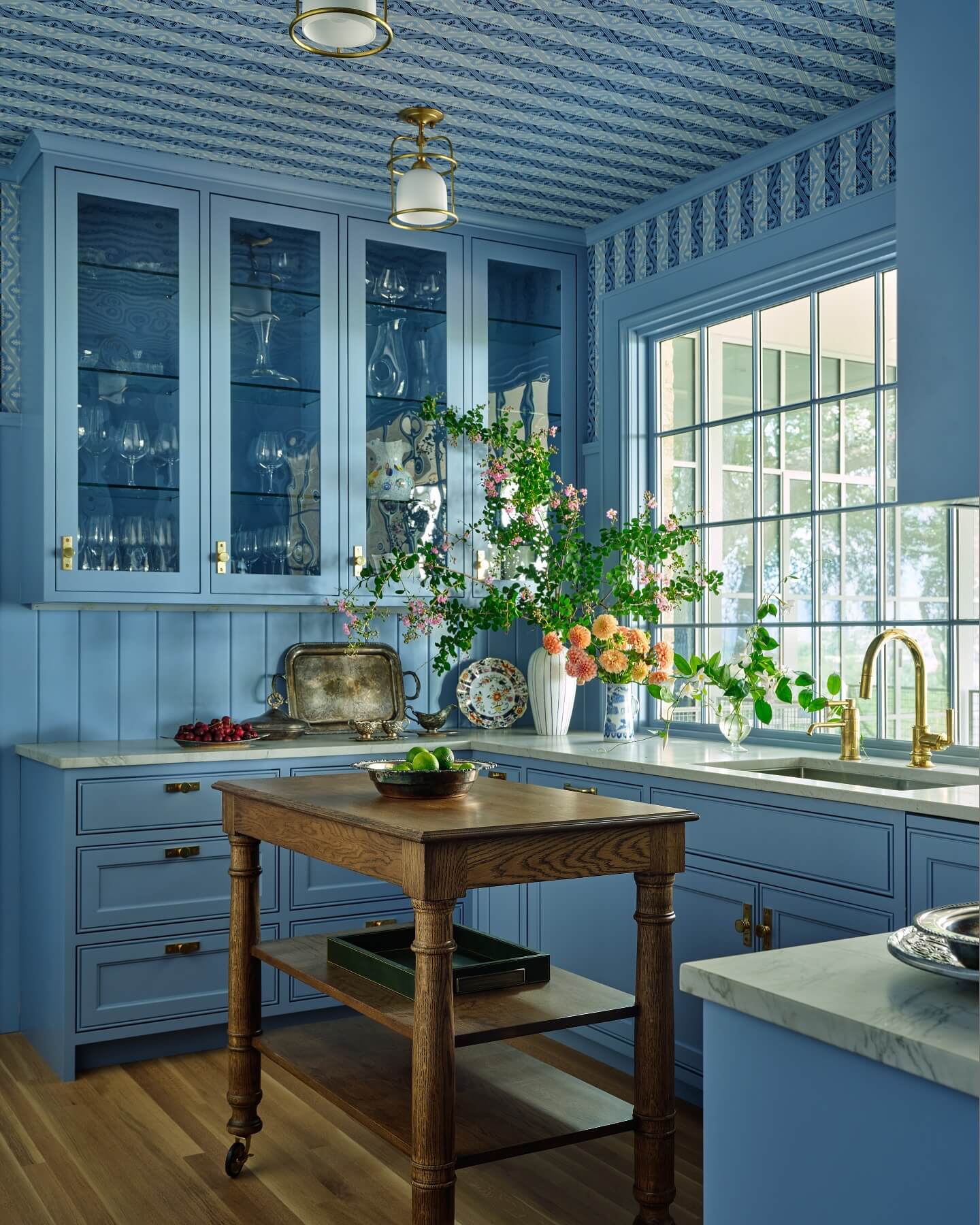 Blue patterned wallpaper makes the ceiling a focal point