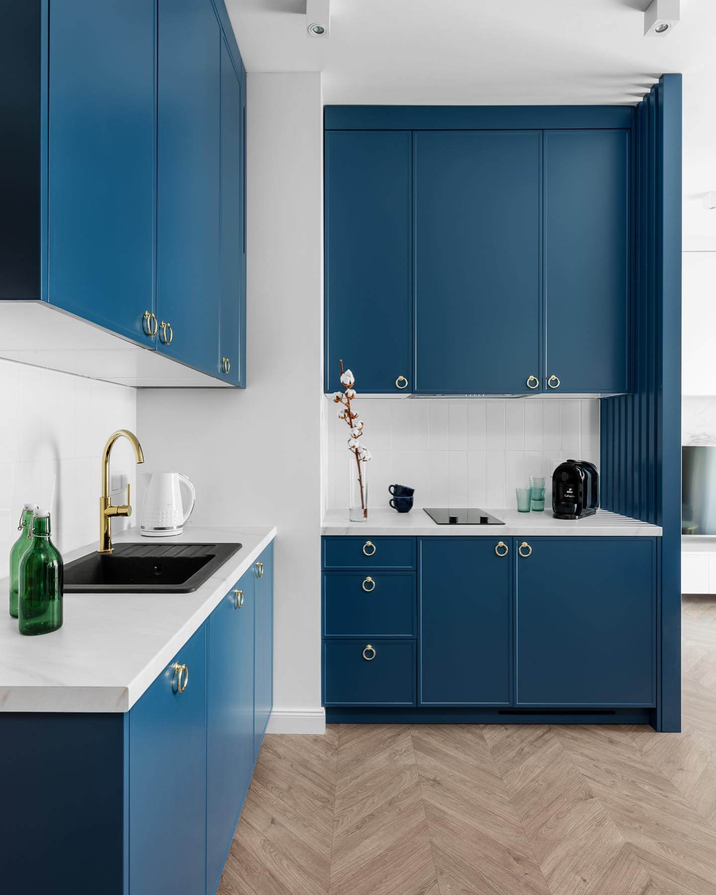 Gold Ring Pulls Add Warmth to Deep Blue Cabinetry