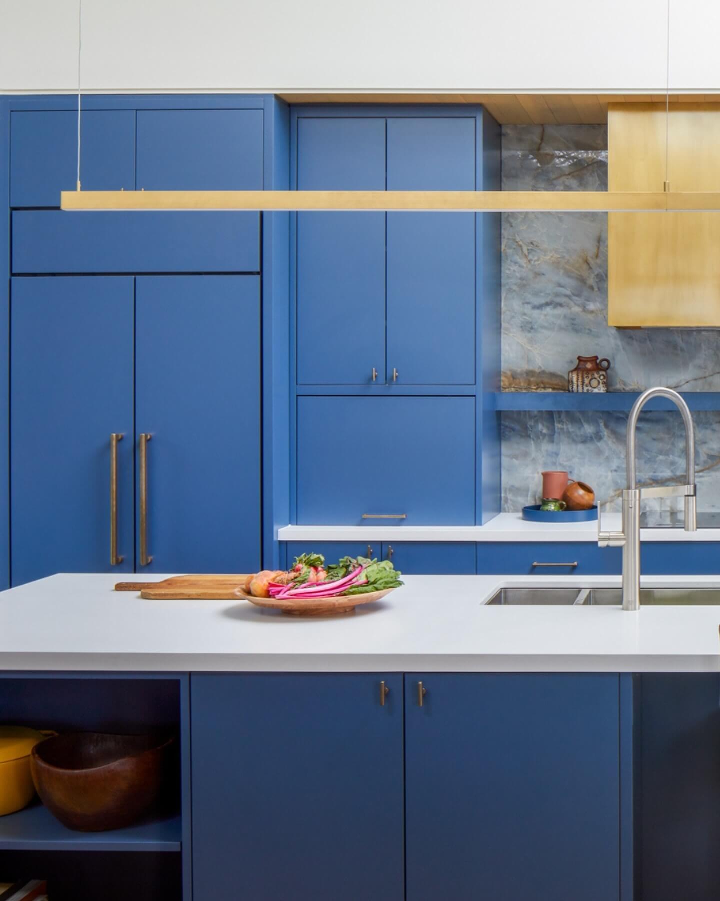 Brass Hood and Marble Backsplash Create a Luxe Focal Point