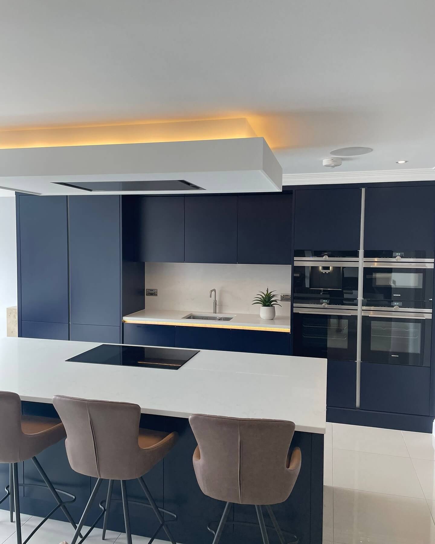 Integrate Ovens into Deep Blue Cabinetry for a Clean Look