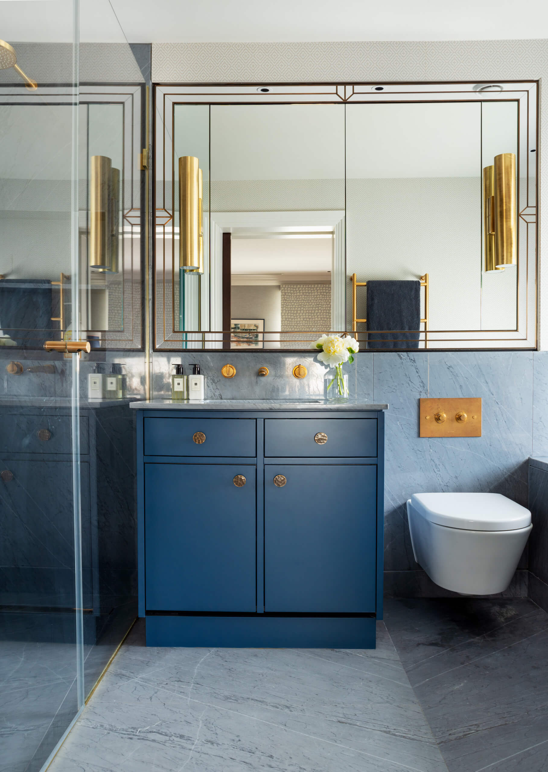 Textured Brass Knobs Add an Artisanal Touch to Deep Blue Cabinetry