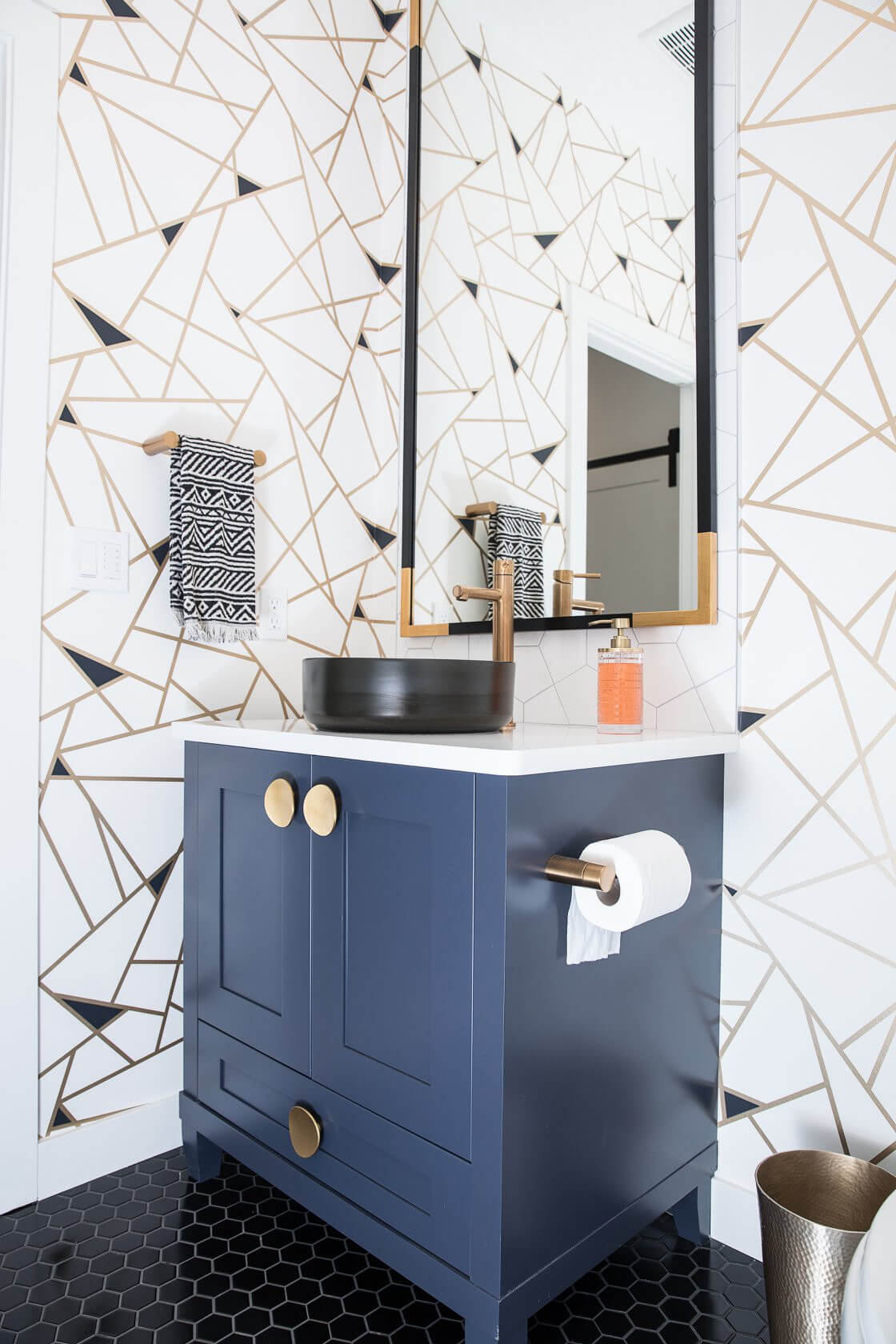 Navy Vanity With Round Gold Knobs and Black Hex Tile