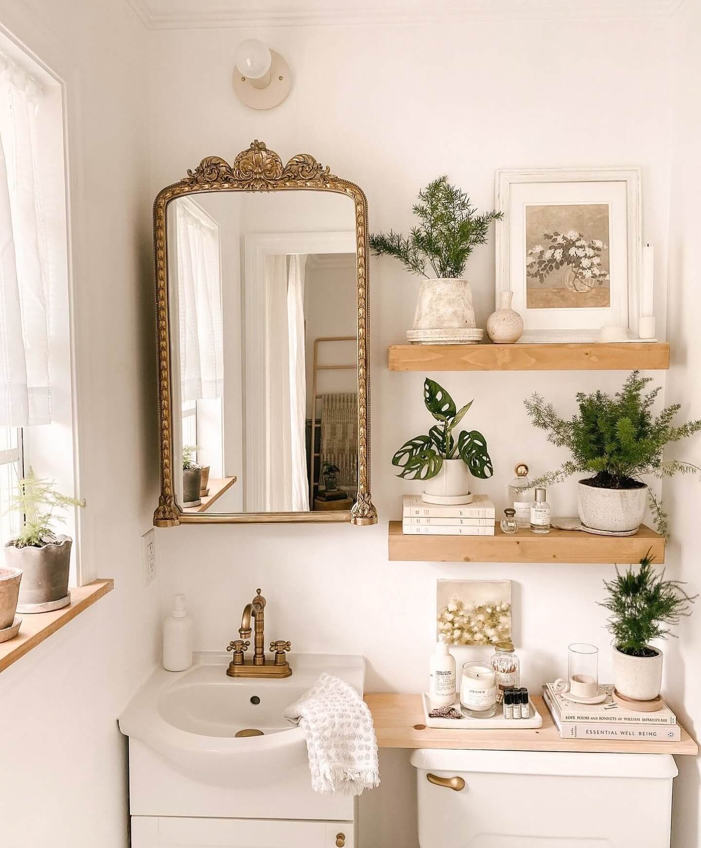 Ornate Gold Mirror Frames a Light-Filled Bathroom