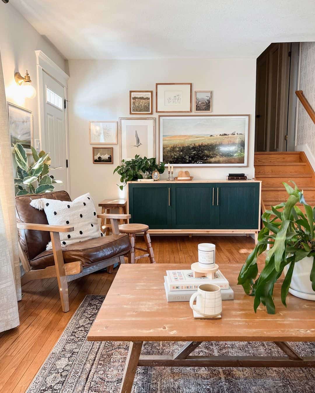 Dark Green Cabinet Pairs With Earthy Toned Landscape Art