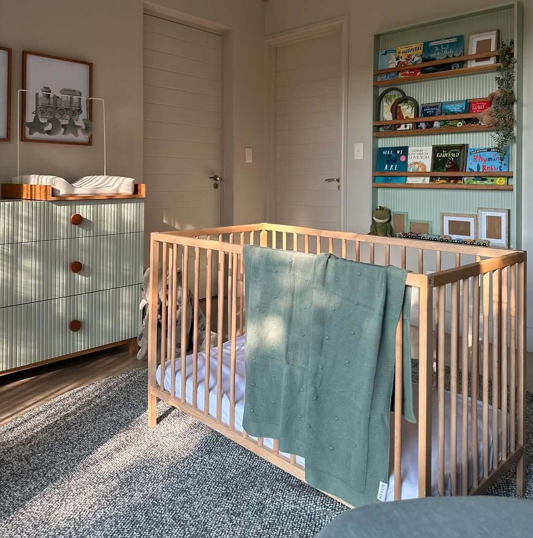 Green Bookshelf Displays Storybooks and Decor Items