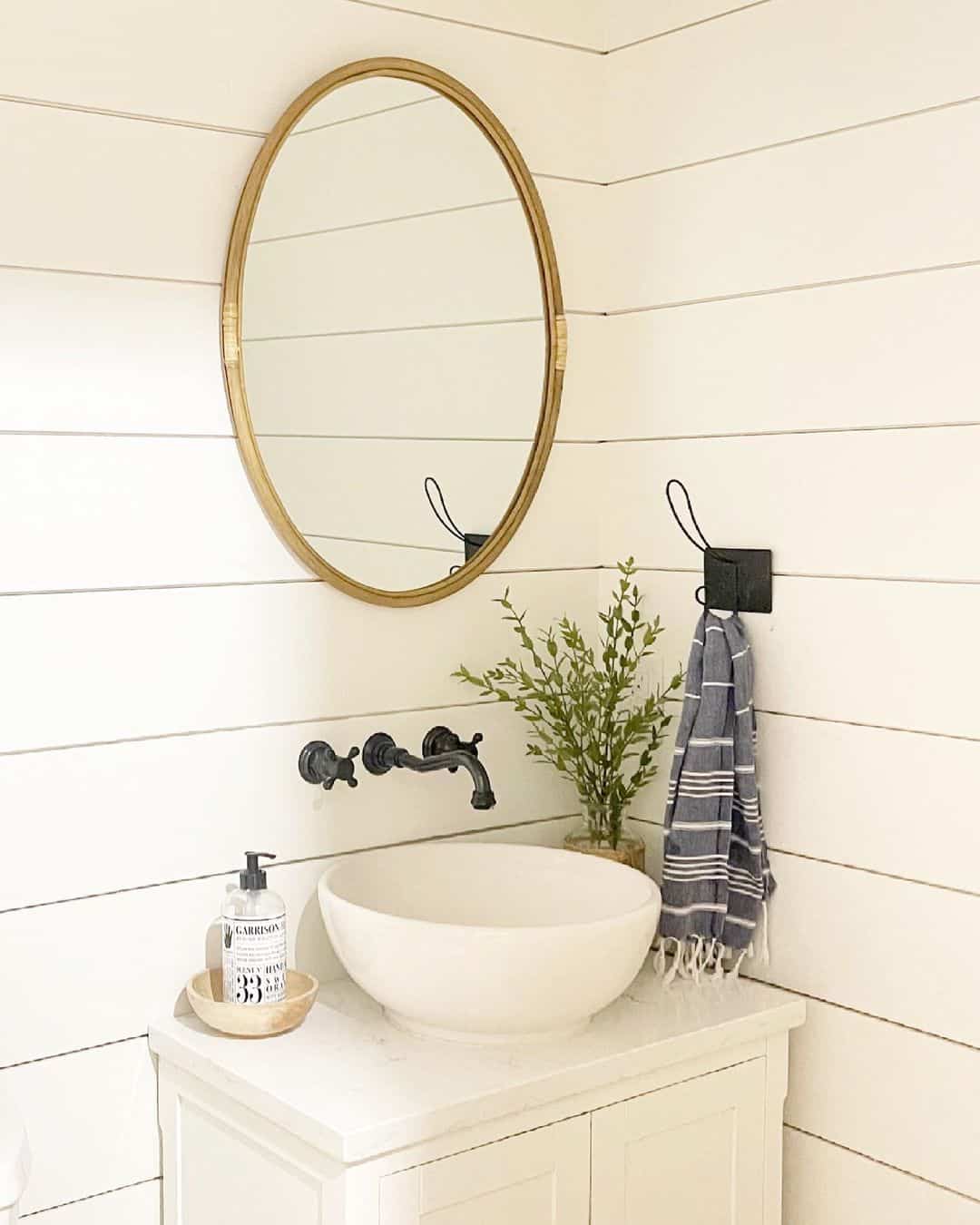 Oval Mirror With Natural Frame Adds Warmth Above the Vanity