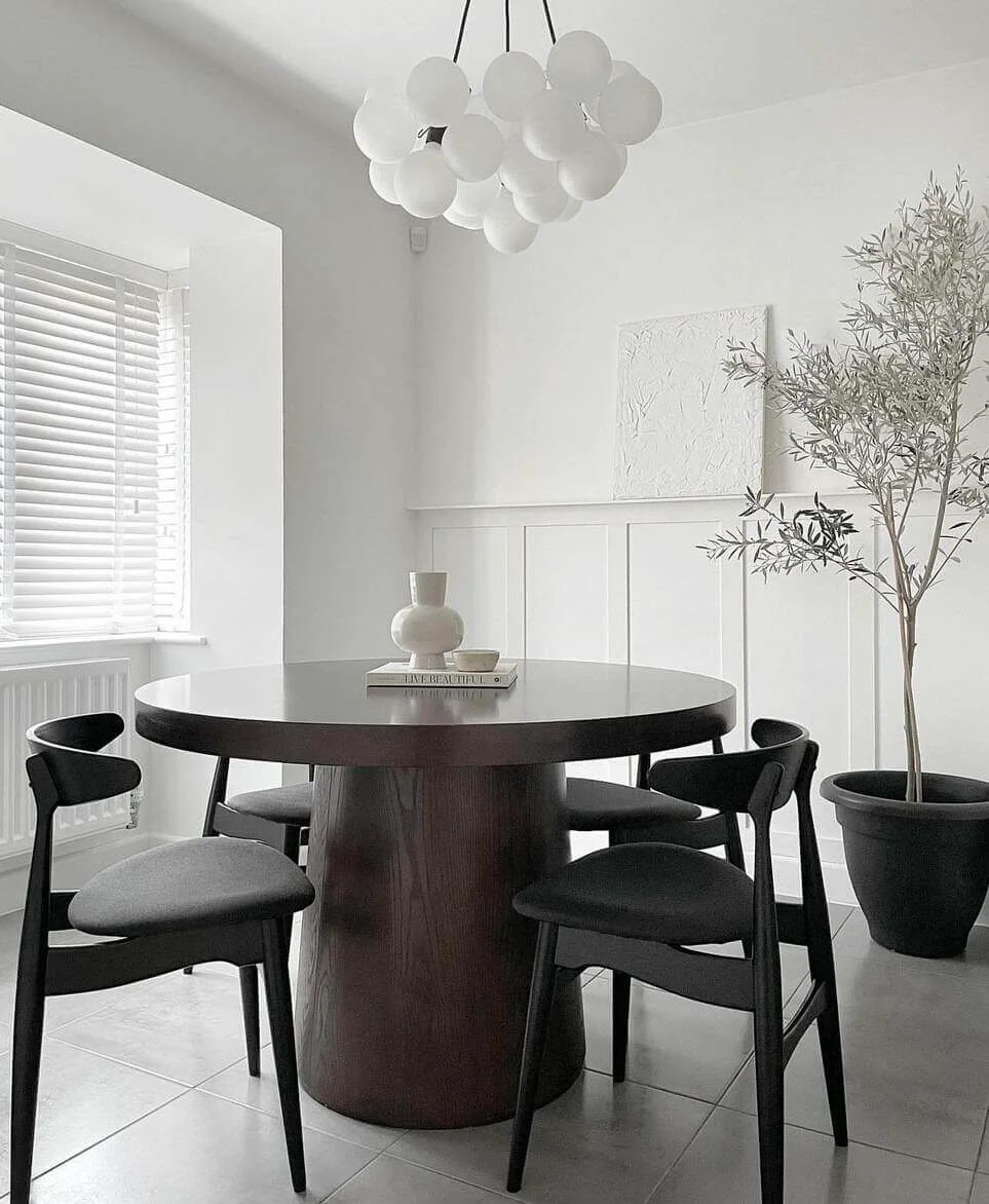 Stack of Books and a Ceramic Vase Create a Simple Centerpiece