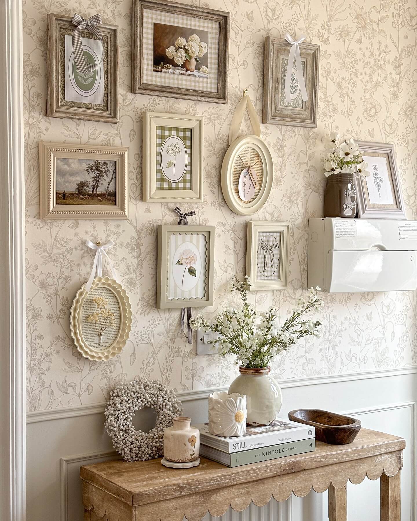 Gallery walls with scalloped frames and ribbon details