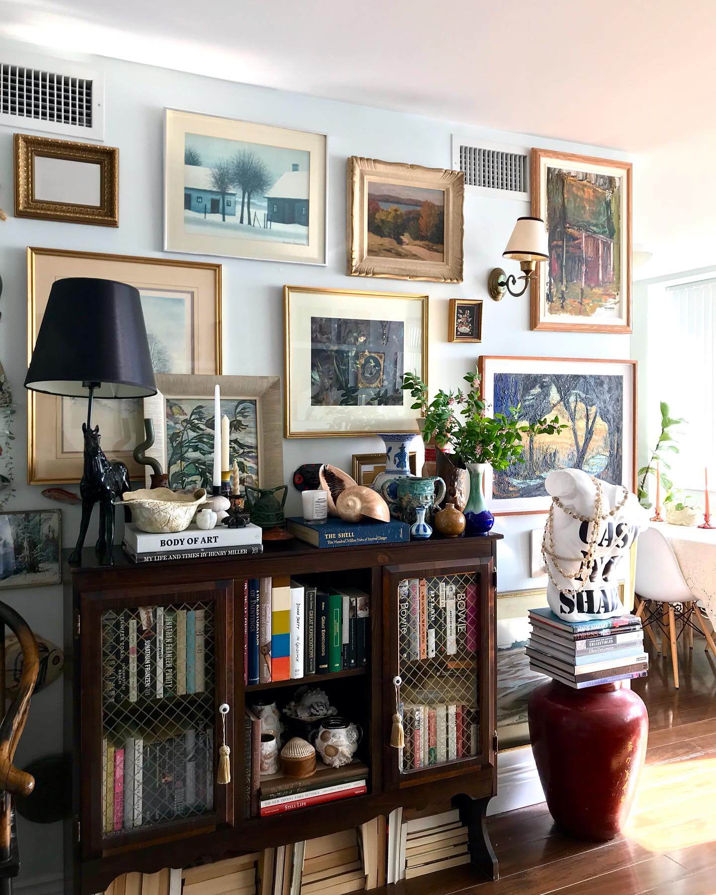 Layer Artwork and Objects on a Dark Wood Cabinet