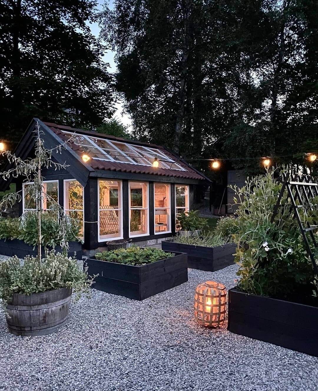 Define a Greenhouse Garden with Black Raised Beds