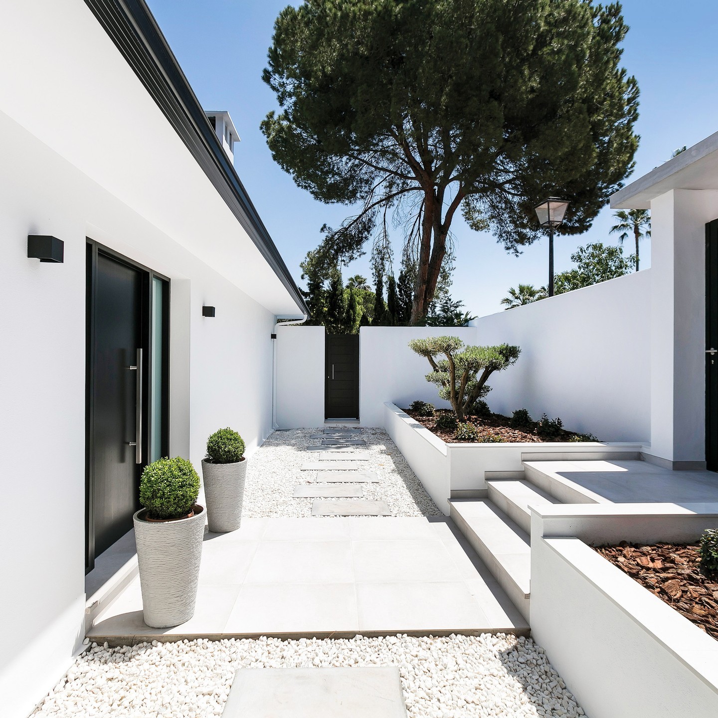 Frame a Path with Tall, Textured Planters