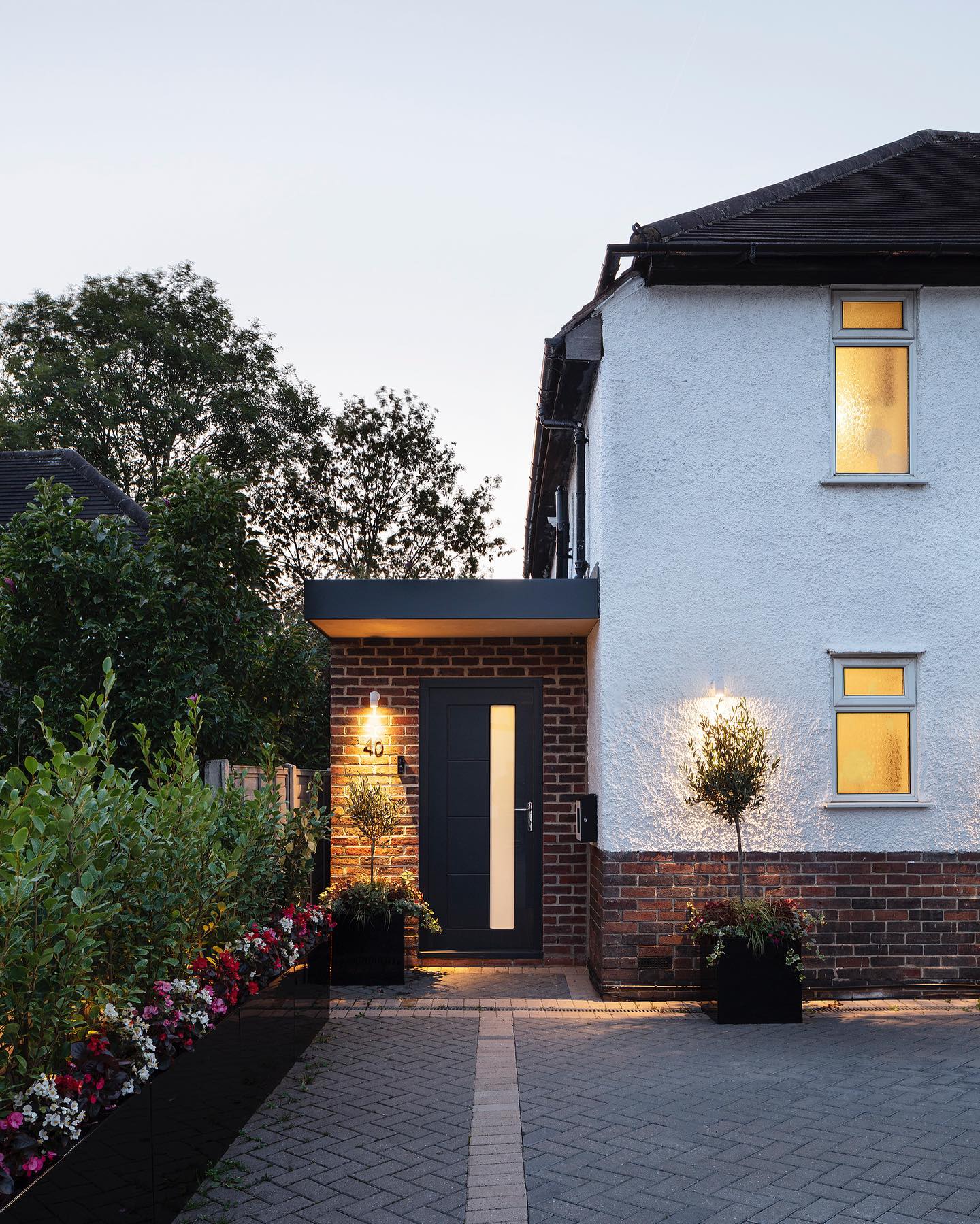 Tall, narrow planters flank the entrance for a modern entryway