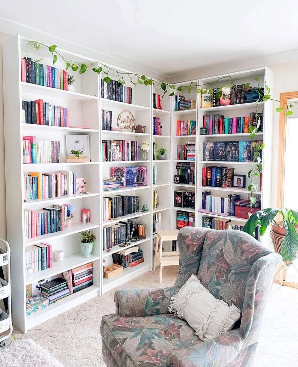 Drape Greenery Over White Corner Bookshelves