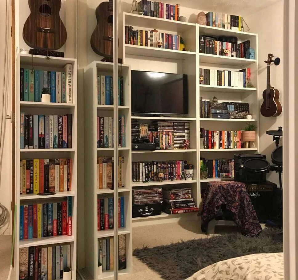 Guitars Hung Above Shelves for a Musical Library Vibe