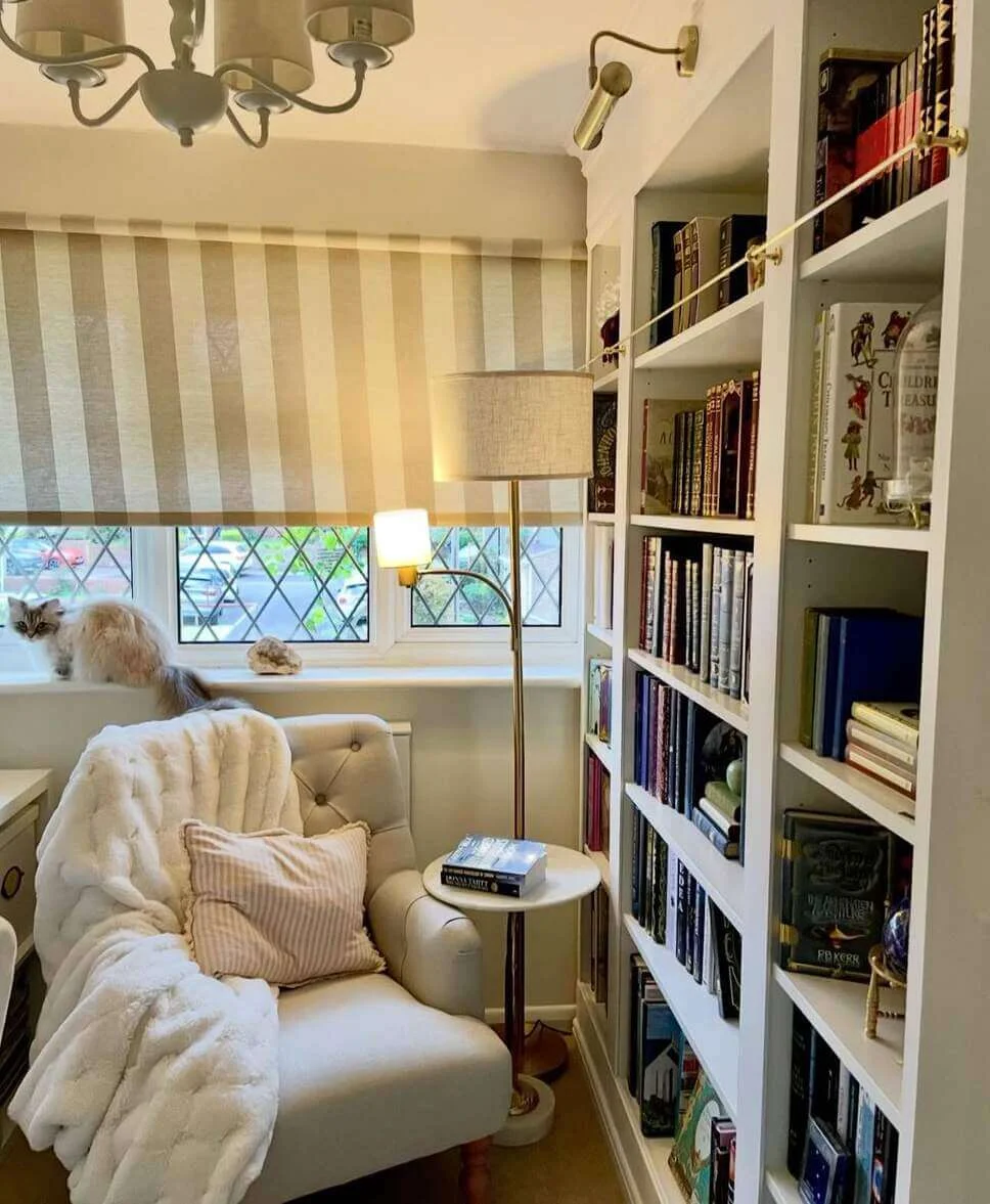 Brass Rods Keep Books From Sliding on White Shelves