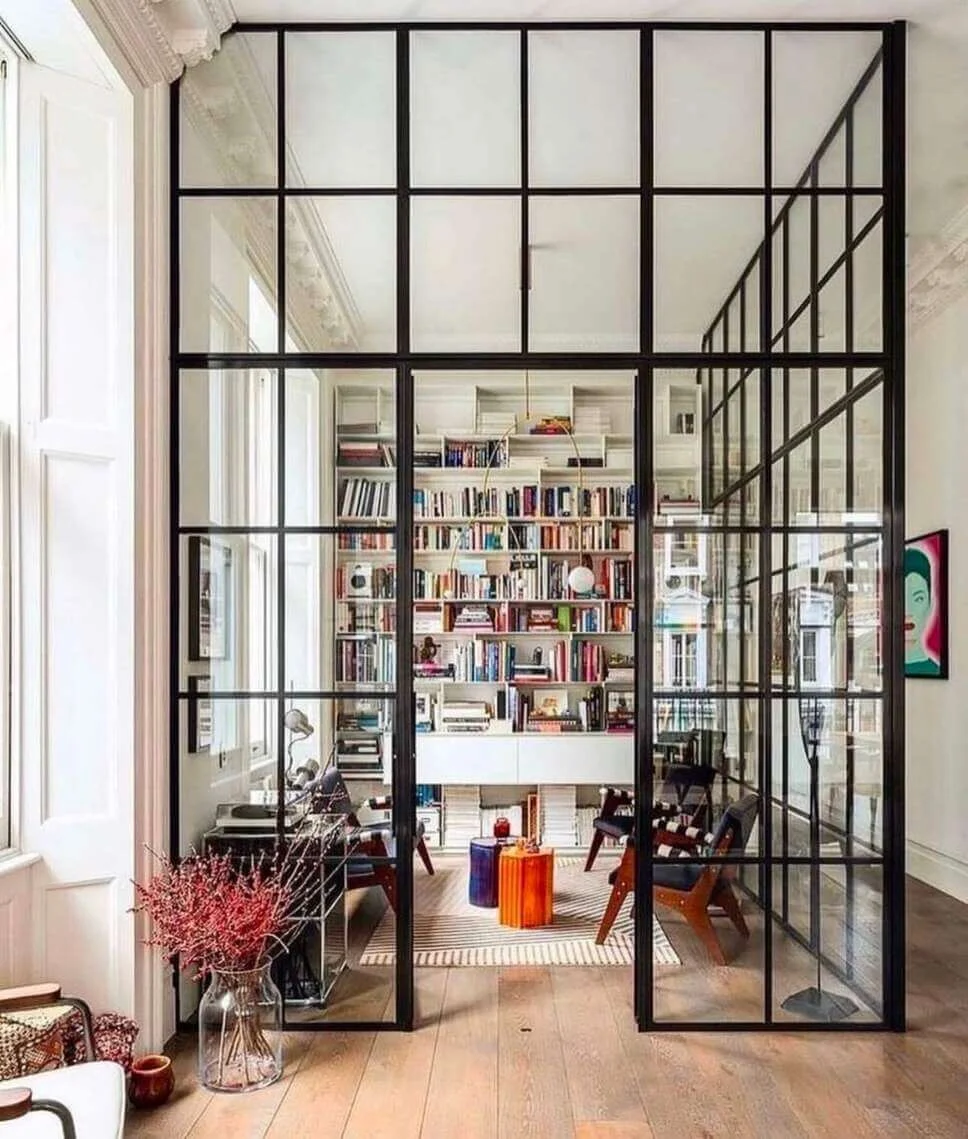 Glass-Paneled Room Divider Creates a Visible Library