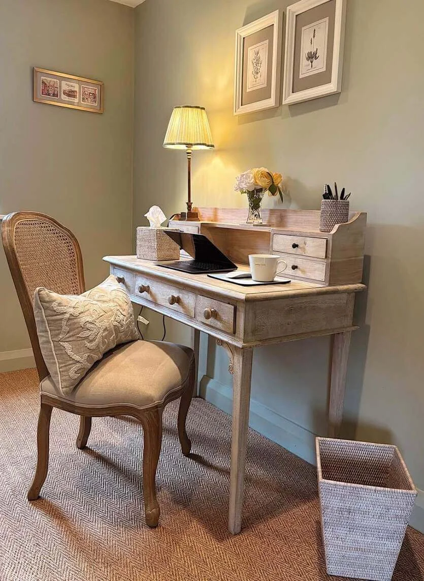 Light-toned secretary desk with integrated drawers organizes supplies