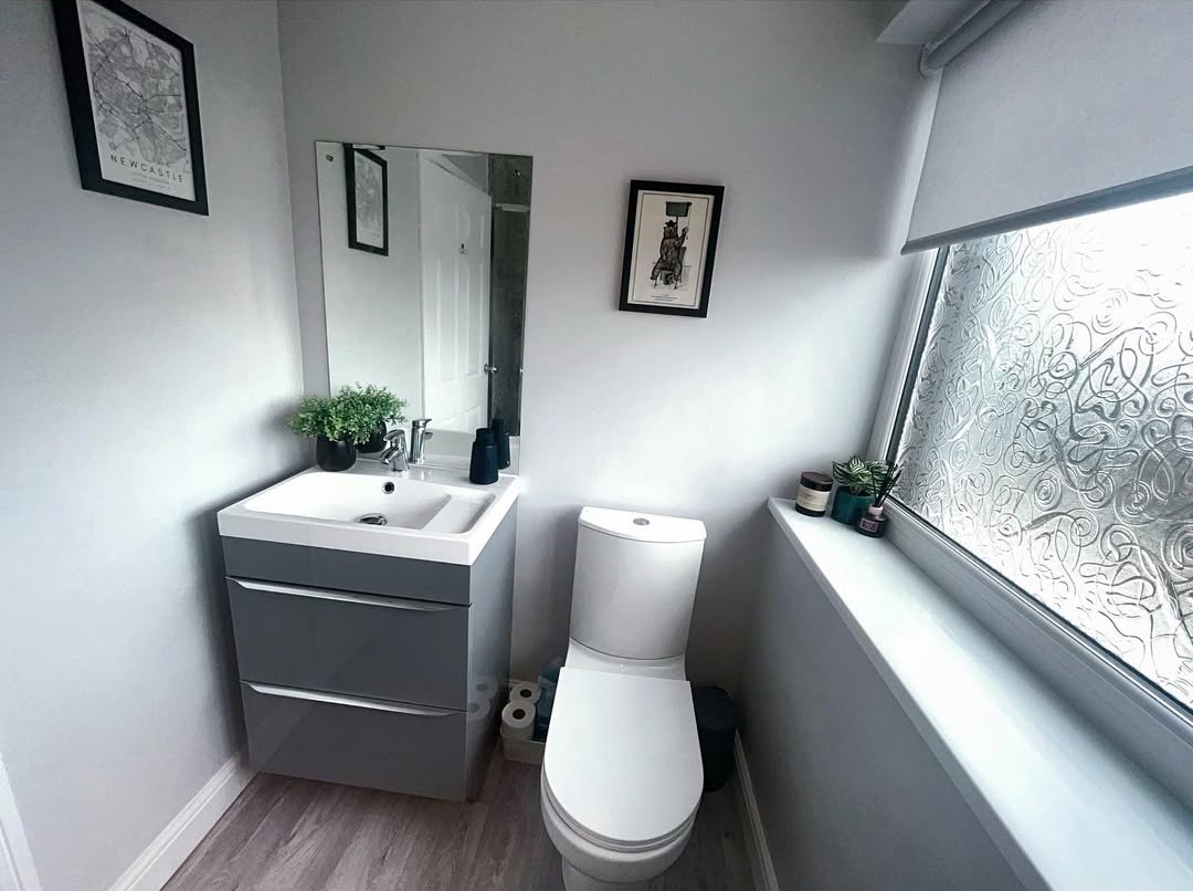 Integrated Drawer Pulls Create a Sleek Glossy Grey Vanity