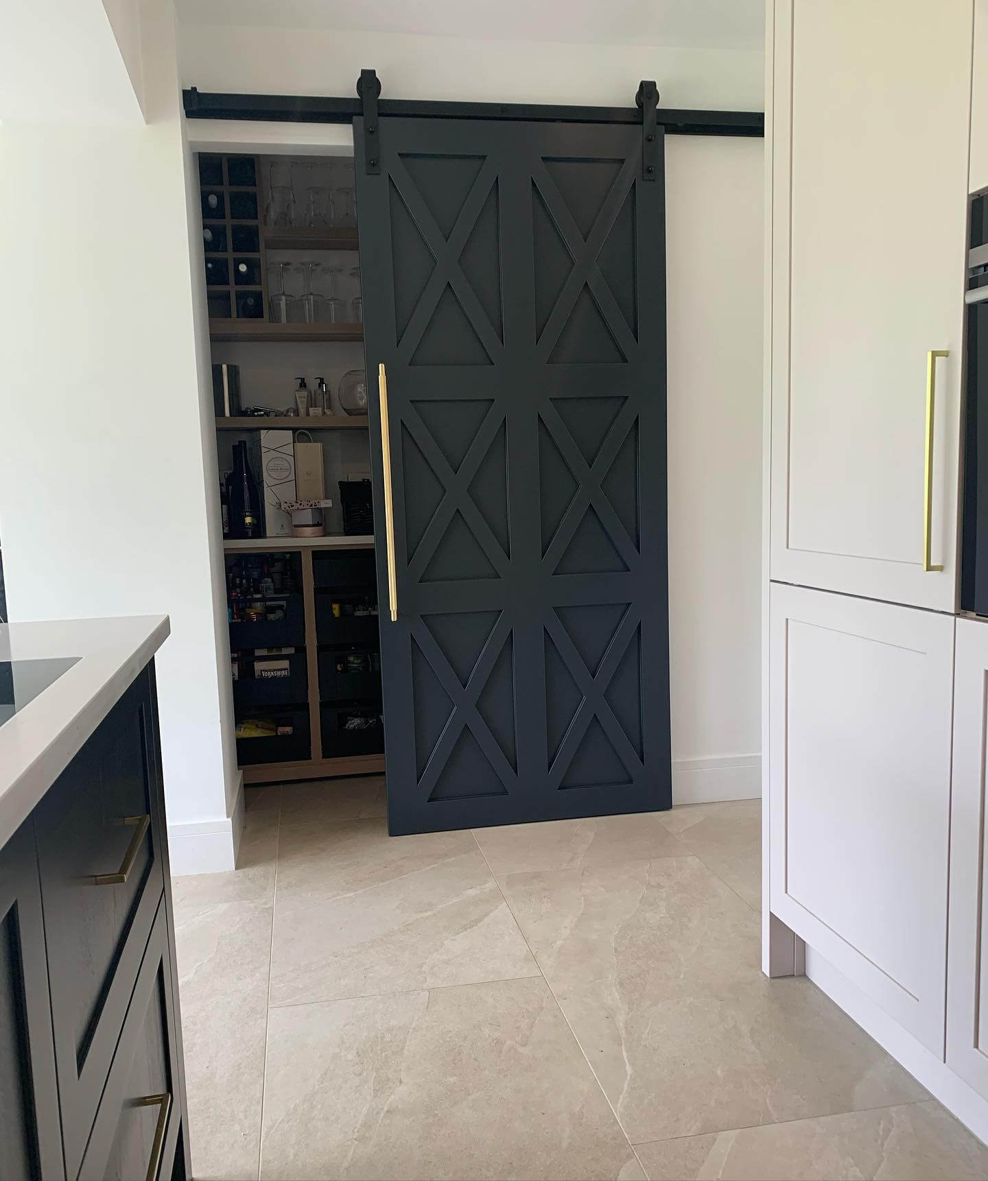 Dark Sliding Barn Door With Geometric X-Panel Design