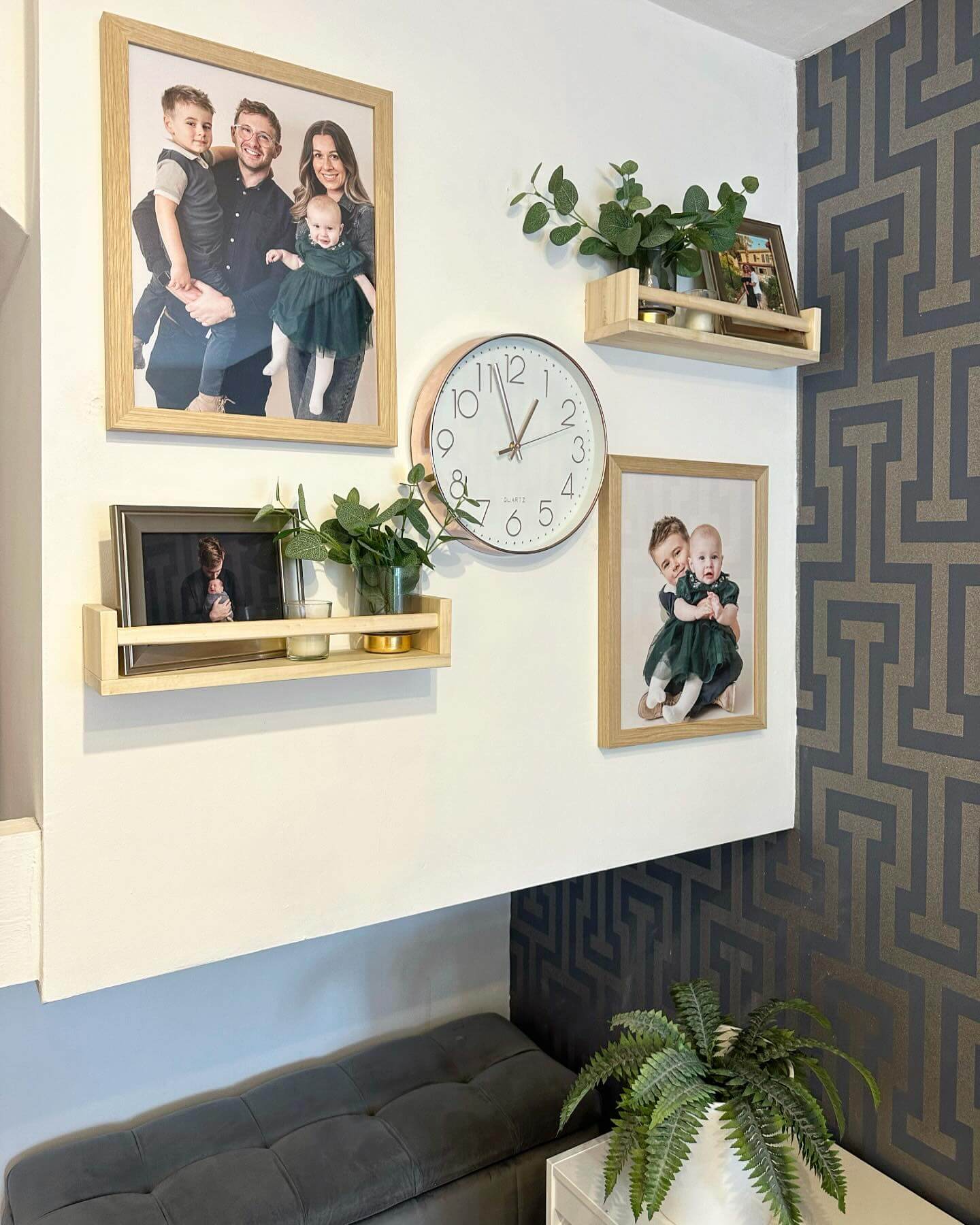 Wooden shelves display framed memories and greenery