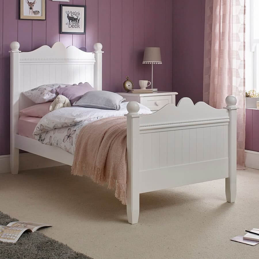 White Bed Frame with Scalloped Headboard Softens Purple Walls
